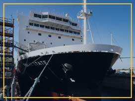 NSMV ship docked at port with clear blue sky in the background.